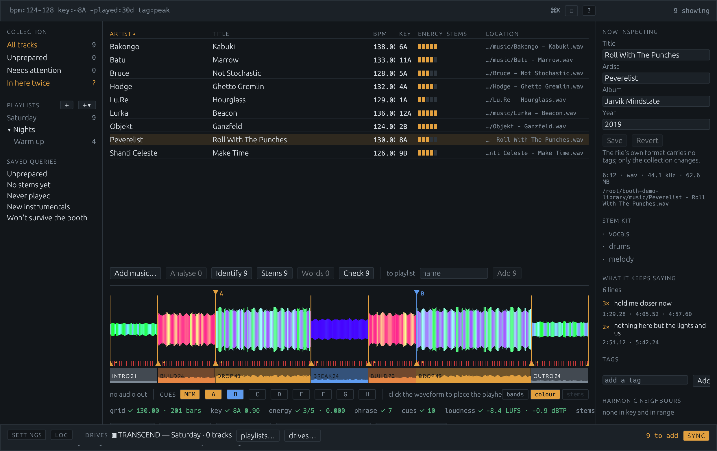 The Booth window: collection and playlists on the left, the track list in the middle, the inspector on the right, a coloured waveform with cue markers and phrase bands below, and the drive dock along the bottom.